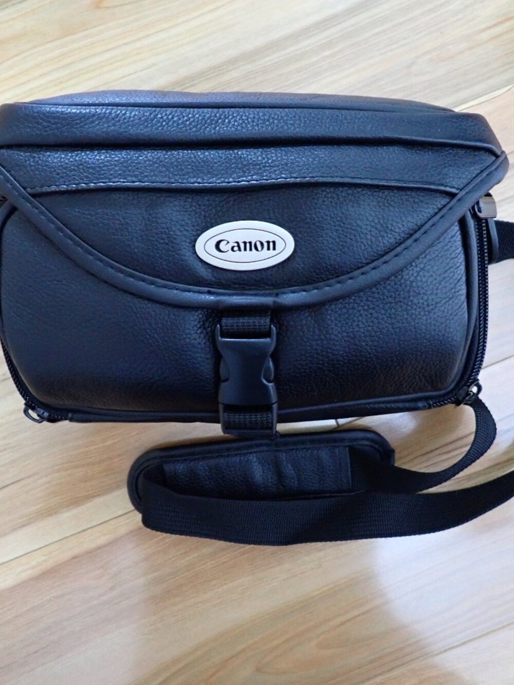 Black leather Canon camera bag with removeable strap